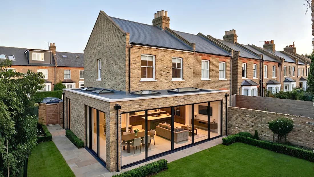 Wraparound extension Barnes London — aerial view of flat roof and rooflights | Sovran Wraparound extension in Barnes, London — aerial view of a single-storey brick extension with a flat roof, three rooflights and full-height glazing onto the garden, by Sovran
